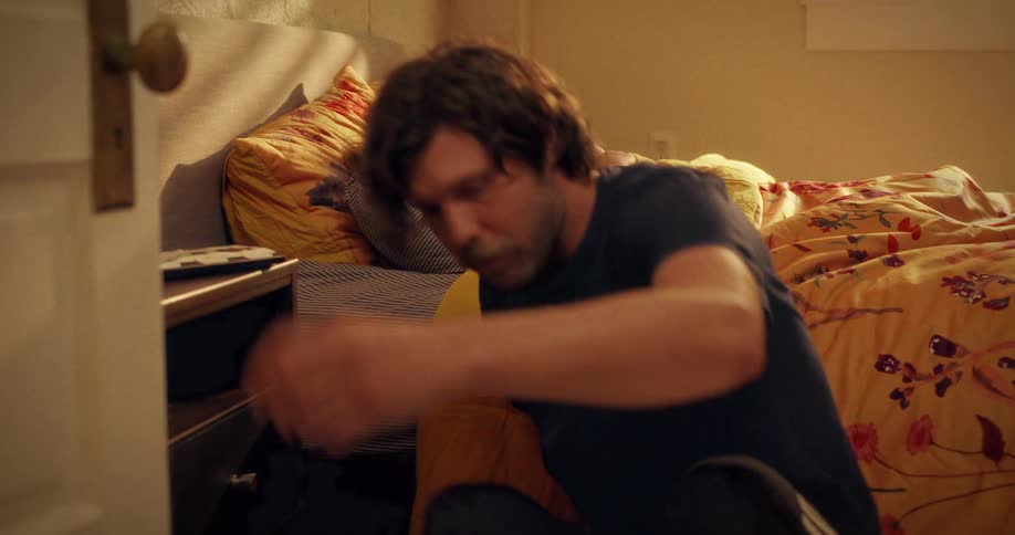 A caring father quietly enters his daughter's bedroom and sits by her bed to watch her sleep