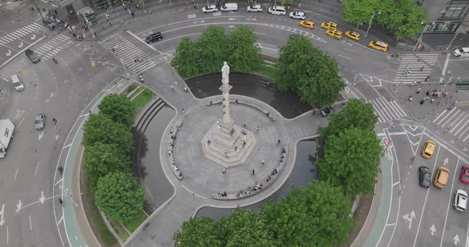 High-angle view tilting down to a top-down perspective of the iconic Columbus Circle monument and traffic circle in New York City