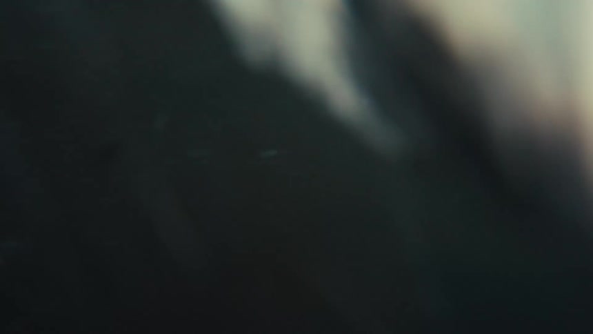 A chaotic point-of-view shot of being tossed by dark ocean waves, submerging and re-emerging from the water