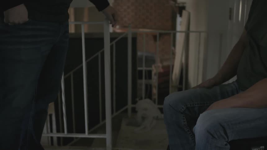 A man in a wheelchair points towards some steps