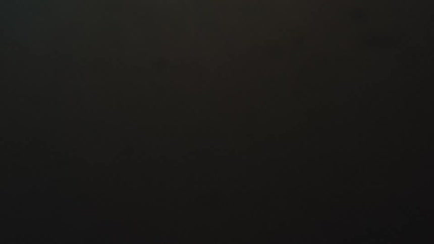 A low-angle view from the ocean surface slowly sinks into the dark depths below at sunset