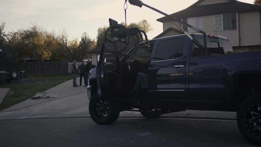 A man gets out of his truck as a wheelchair lowers