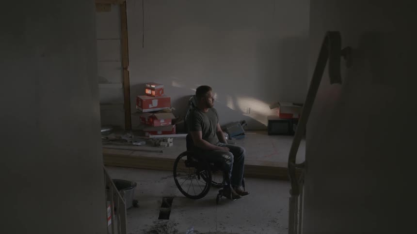 A man in a wheelchair is in the garage
