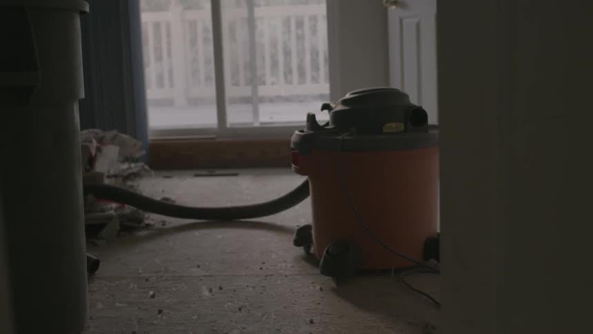 A large vacuum sits in a room