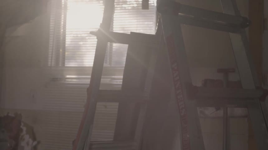Sun shining through the window in a cluttered room