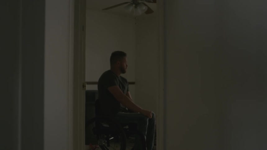 A man is in a wheelchair past the doorway