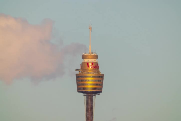 A time-lapse of the iconic Sydney Tower Eye as pink-hued clouds quickly dissipate in the sky during a golden sunset