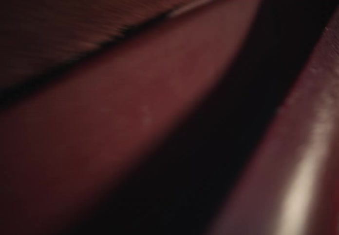 An abstract macro probe shot explores the textures inside a red leather wallet