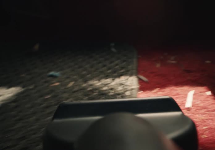 A close-up, point-of-view shot shows a vacuum cleaner sucking up dirt from a dirty red car carpet