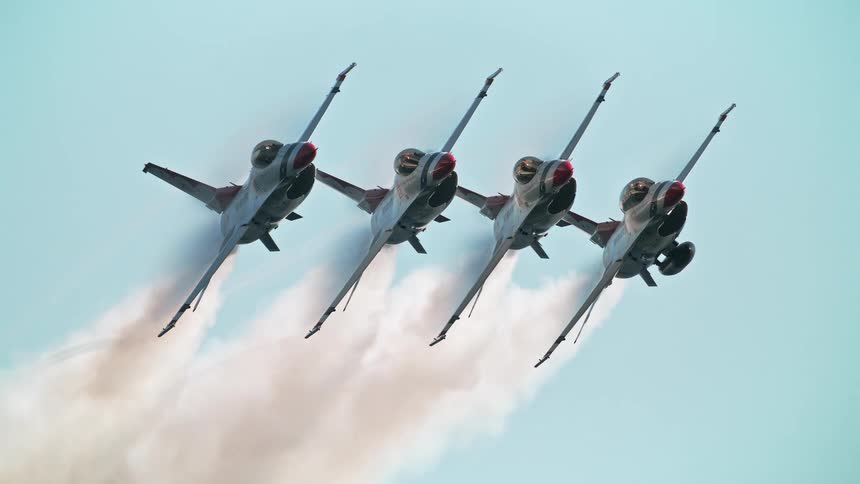 A cinemagraph loop shows four fighter jets flying in perfect diamond formation in super slow motion