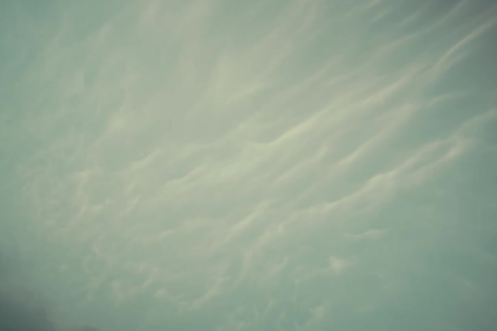 Clouds slowly moving across a blue sky