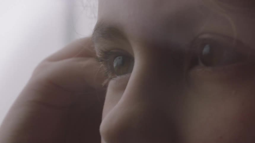 The curious and expressive eyes of a young child are shown in a dreamy, extreme close-up slow-motion shot
