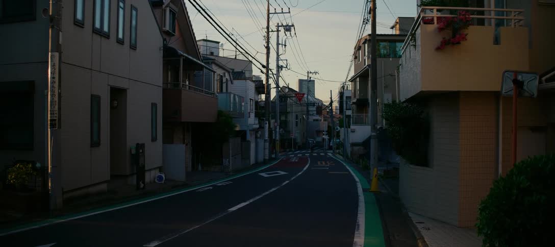 A peaceful residential street in a Japanese neighborhood is quiet and empty during the golden hour