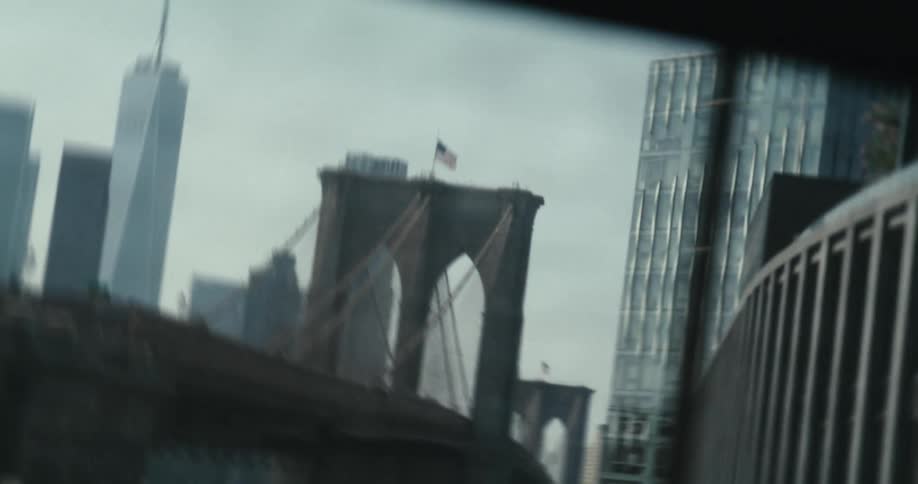Moody handheld shot revealing the iconic Brooklyn Bridge and Manhattan skyline on an overcast day