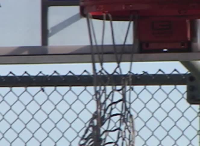 A close up of a basketball missing the hoop in slow motion at an outdoor park in Los Angeles