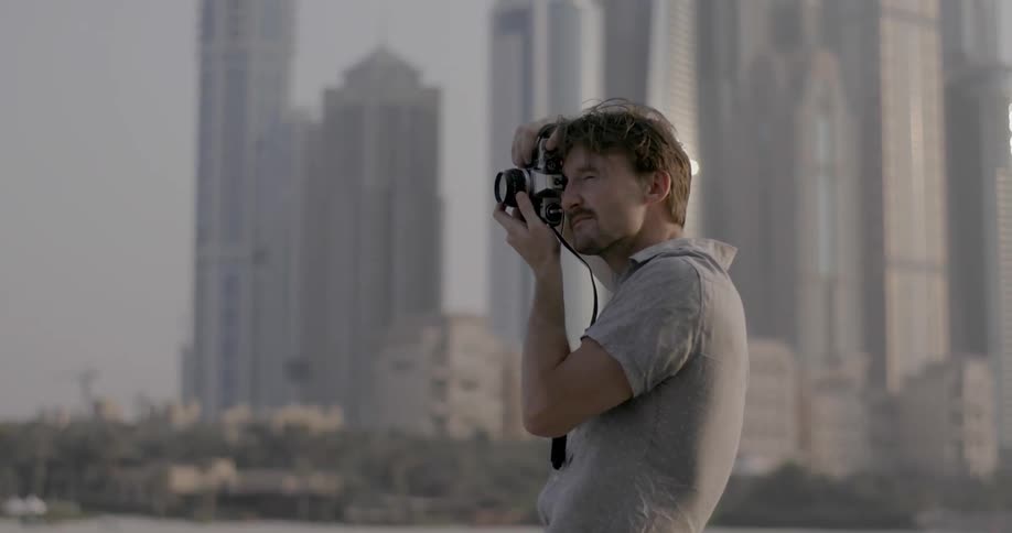 A man is taking photographs on a windy day
