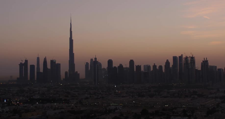 City skyscrapers are shown at sunset
