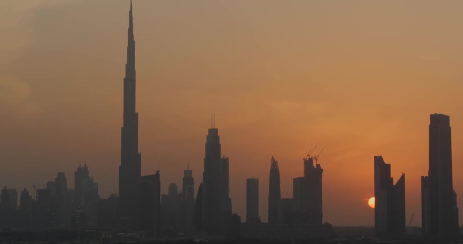 The sun is setting behind the city