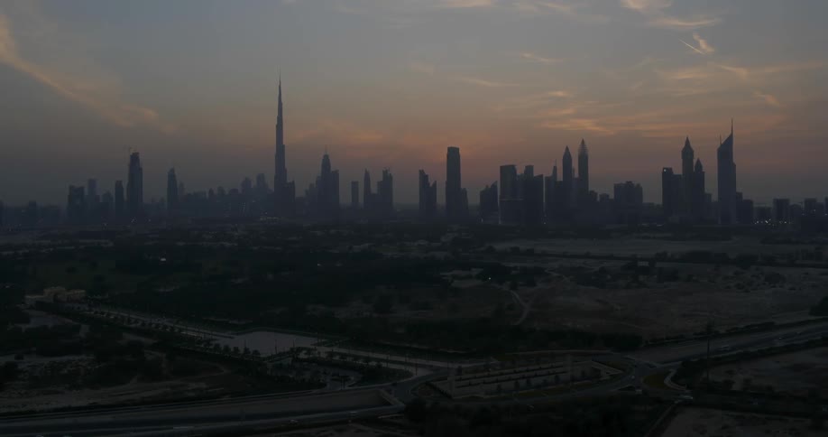 The sun is setting over the city ahead