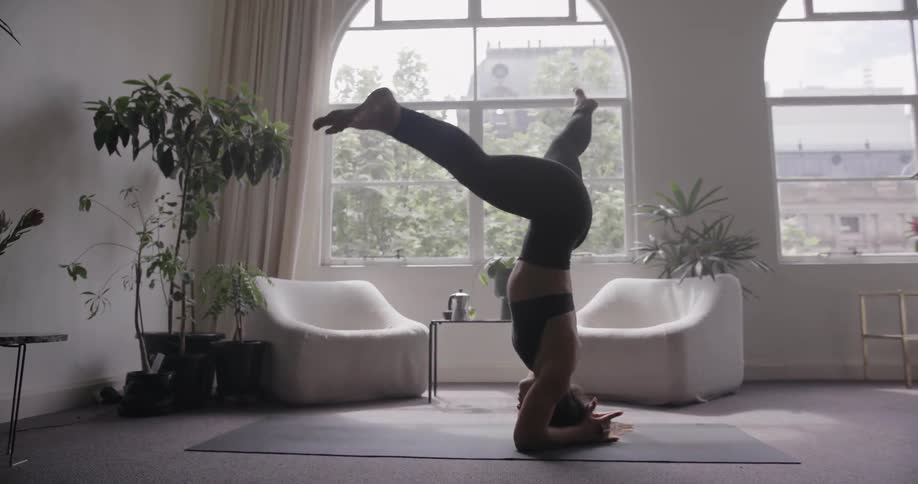 A woman stands on her head doing yoga