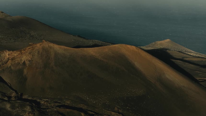 Sunlight moves across a volcanic crater on a desolate island overlooking the ocean in this epic time-lapse