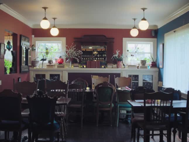 The eclectic and colorful dining room of an empty vintage-style restaurant