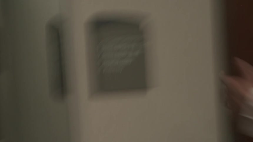 A directional sign on the wall of a hospital hallway indicates the location of guest suites, the lobby, and the pharmacy