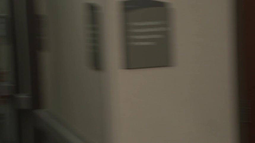 A chaotic and urgent point-of-view shot of a doctor and others rushing through a hospital hallway