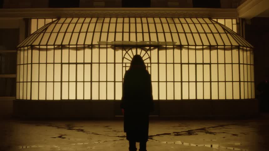 A person is standing in front of a building