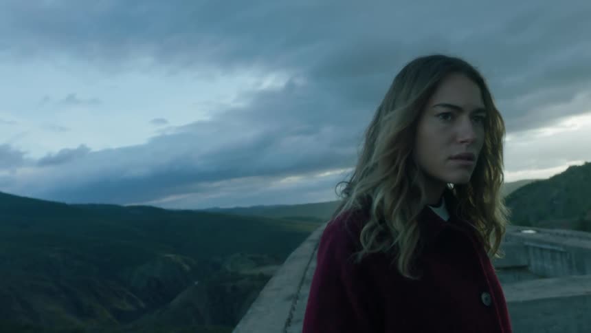 A woman is looking worried on a windy day