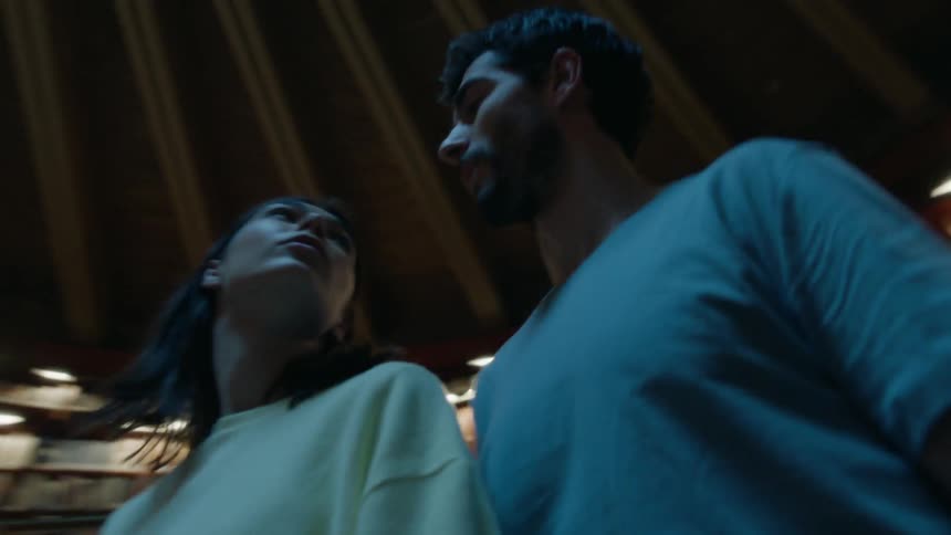 Two people look up in a library
