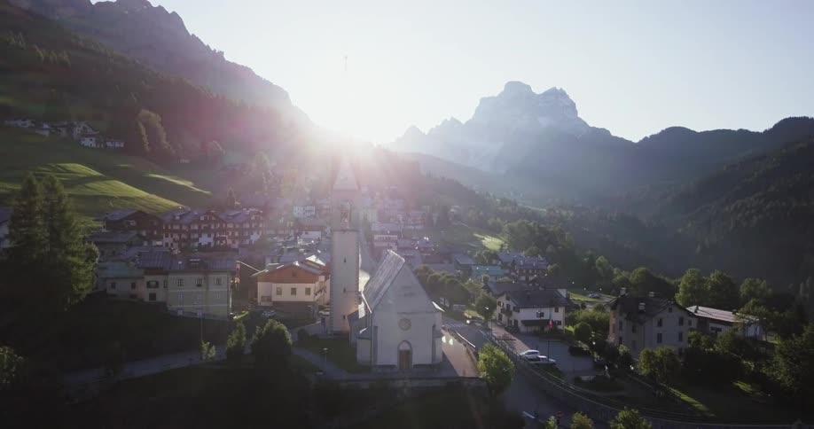 A town sits on a green hill