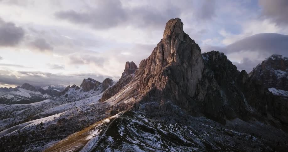 A view of a large rock on a mountain covered in snow