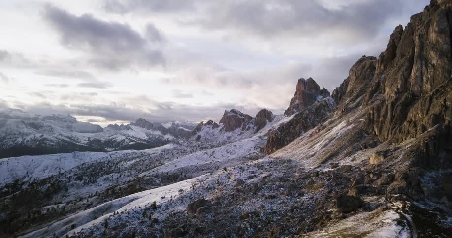 The hills are covered with snow leading to mountains