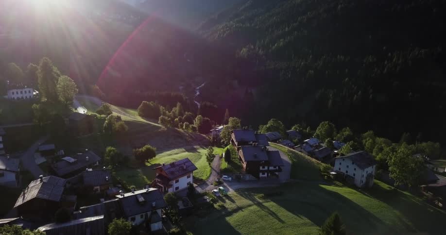 Houses are on the green pastures below
