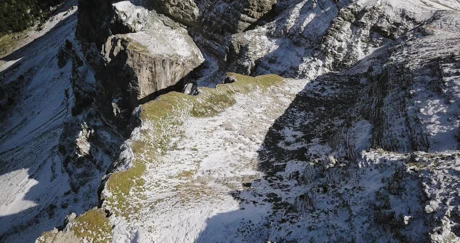 Aerial view of snow covered mountains on a sunny day