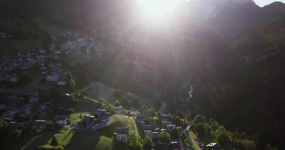 The sun is rising above the mountain ahead