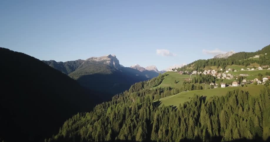 Village homes sit on a green hill top