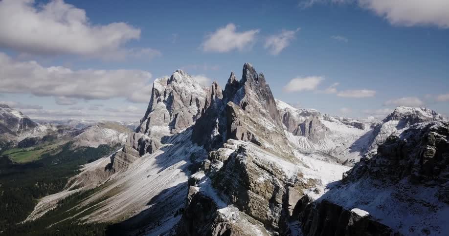 The mountains are covered with front with grass below