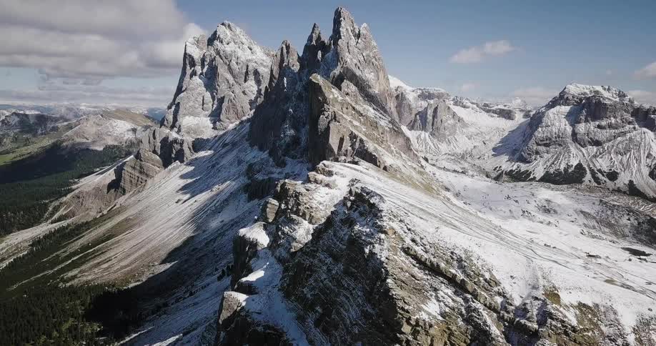 Tall mountain peaks have a light dusting of snow on them