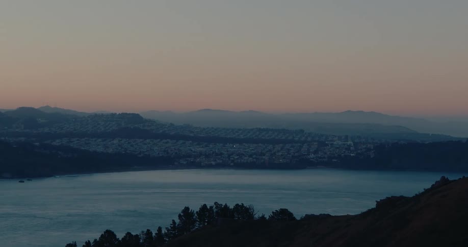A tranquil twilight time-lapse of San Francisco across the bay as the city lights begin to twinkle