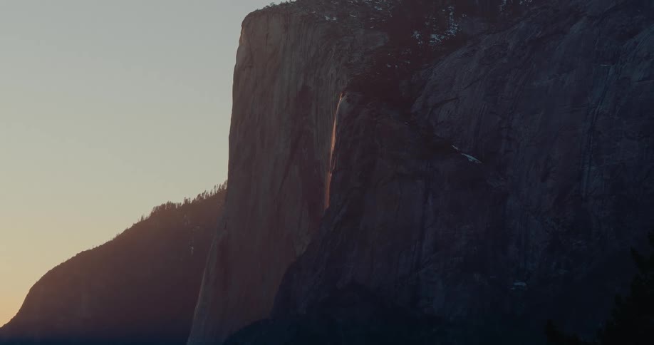 Golden light from the setting sun spectacularly illuminates the famous Firefall at Horsetail Fall on El Capitan in Yosemite National Park