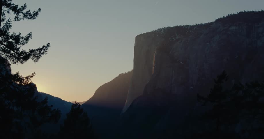 A breathtaking sunset pan reveals the famous 'Firefall' on Horsetail Fall in Yosemite National Park