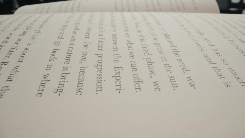 A super close-up shot moves along the lines of text in an open book