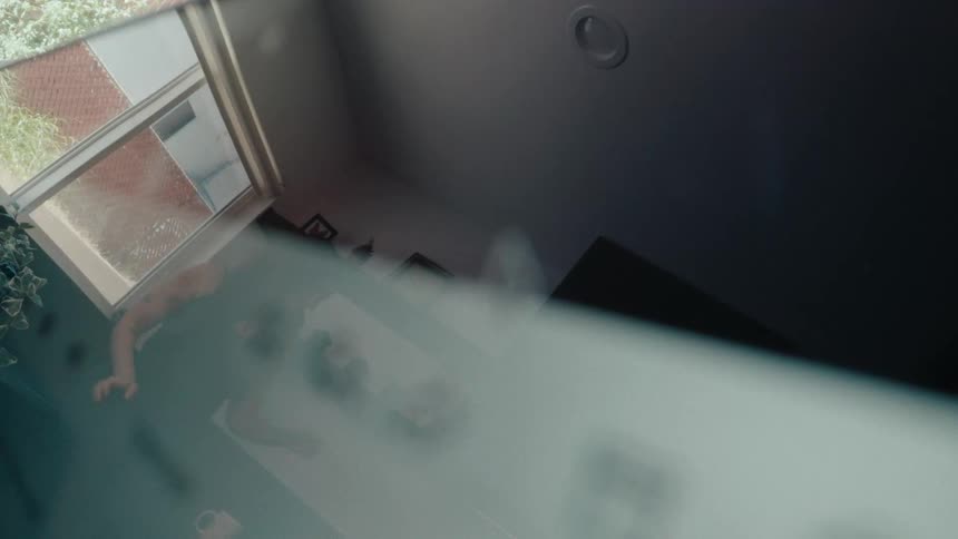 A close-up of a mouse cursor clicking the send icon on an email client, then pulling focus to the user's reflection on the screen