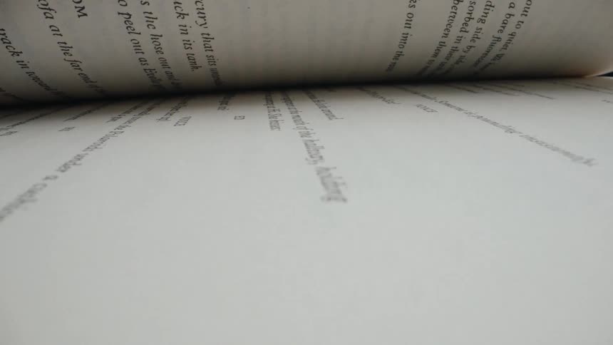 A unique worm's-eye view captures the pages of a book flipping by in a continuous motion