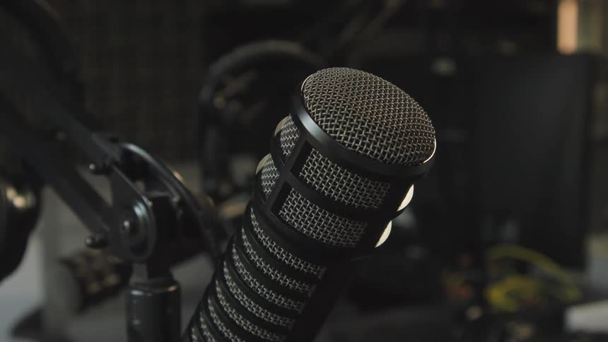 A close-up shot of a finger tapping on a studio microphone to test the sound