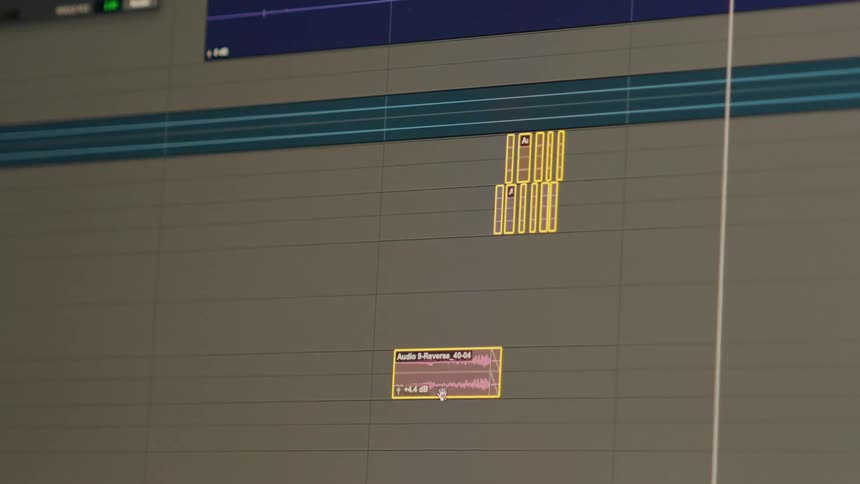 Close-up of a video editor selecting and deleting clips from a software timeline during post-production
