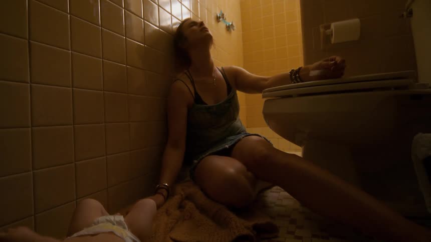 A drug-addicted mother overdoses on the bathroom floor, leaving her infant baby helpless beside her