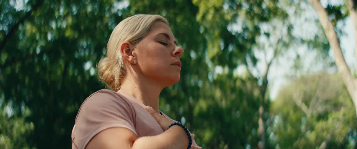 A young woman finds a moment of peace and tranquility while meditating in nature